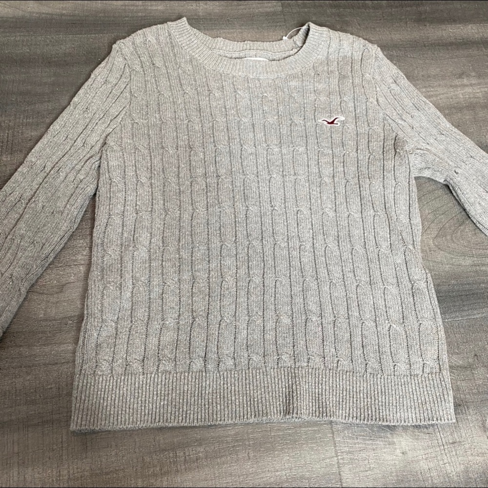 Gray knit sweater.